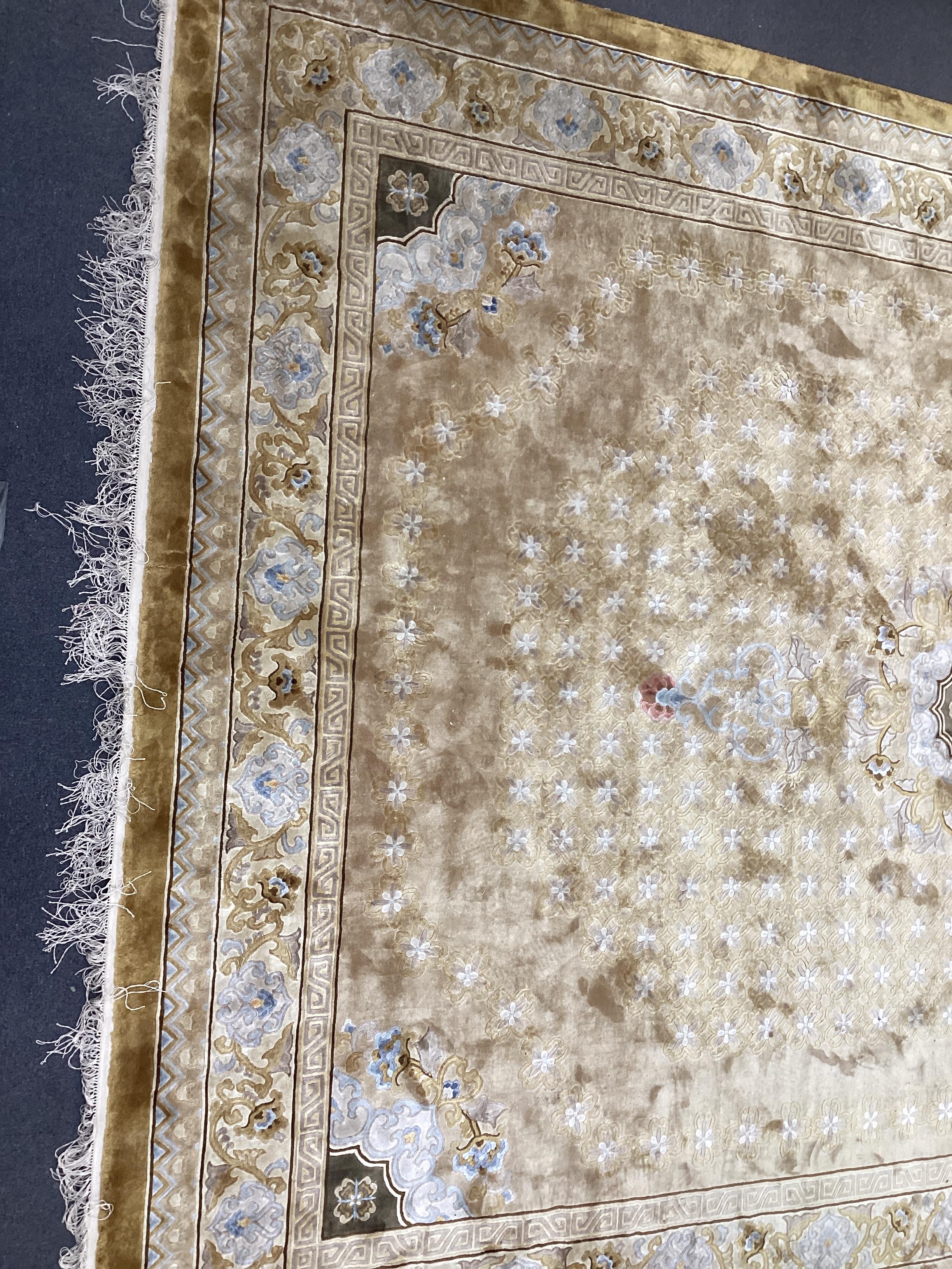 A Chinese gold ground carpet, 370 x 280cm